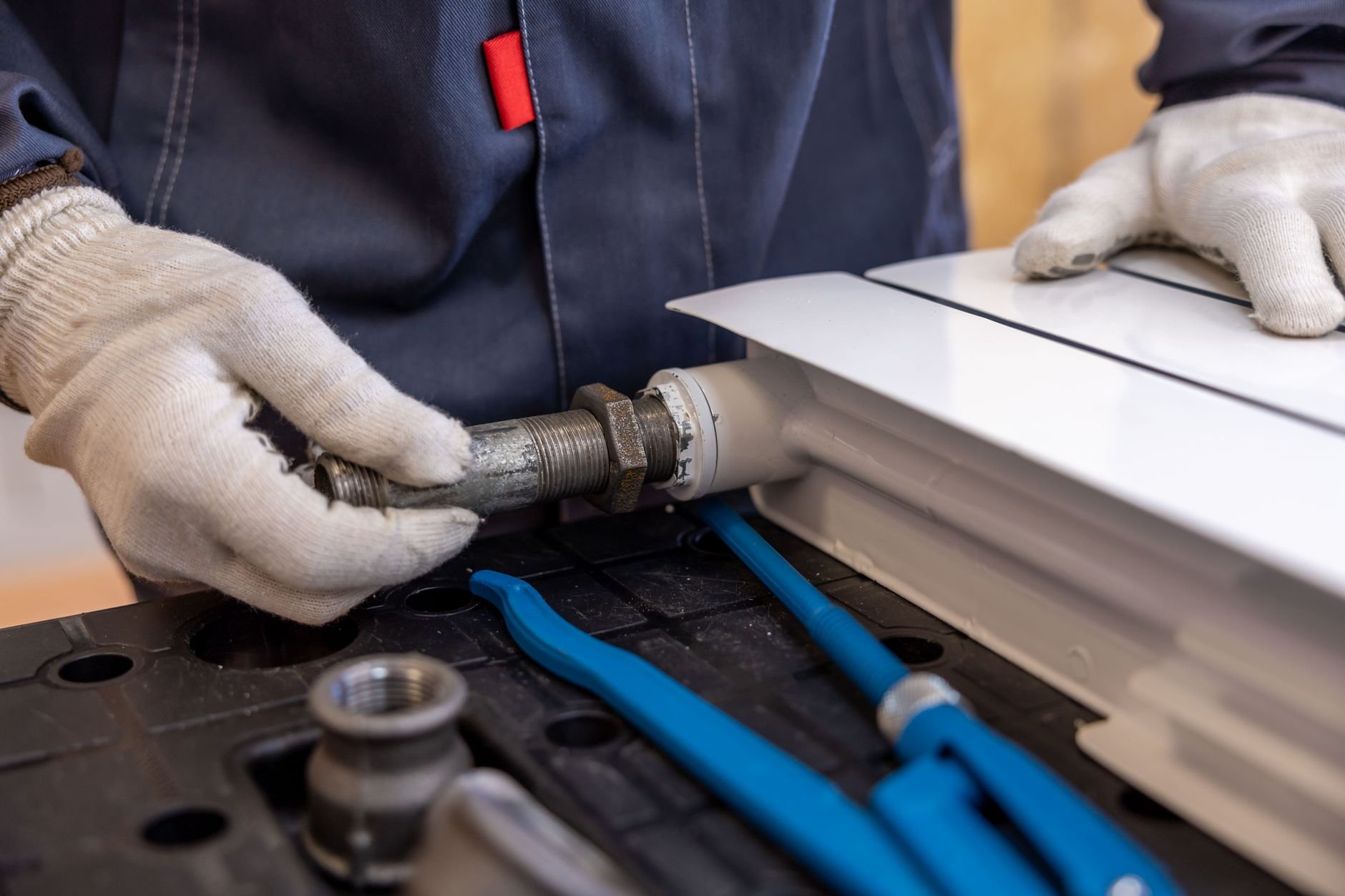 Plumber using specialized tools to install pipe fittings